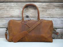 Load image into Gallery viewer, This high-quality genuine leather sports duffle bag is a must-have for any athlete or traveler. Made with the finest materials, it offers durable and stylish storage for all your essentials. Its spacious design and multiple pockets provide practicality and convenience, making it the perfect companion for any adventure.