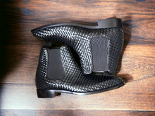 Load image into Gallery viewer, Expertly crafted and stylish, these black woven leather Chelsea boots are the perfect addition to any man&#39;s wardrobe. With a sleek and fashionable design, these boots will elevate any outfit while providing comfort and durability. Perfect for any dressy occasion, these handmade boots are a must-have for the modern man.